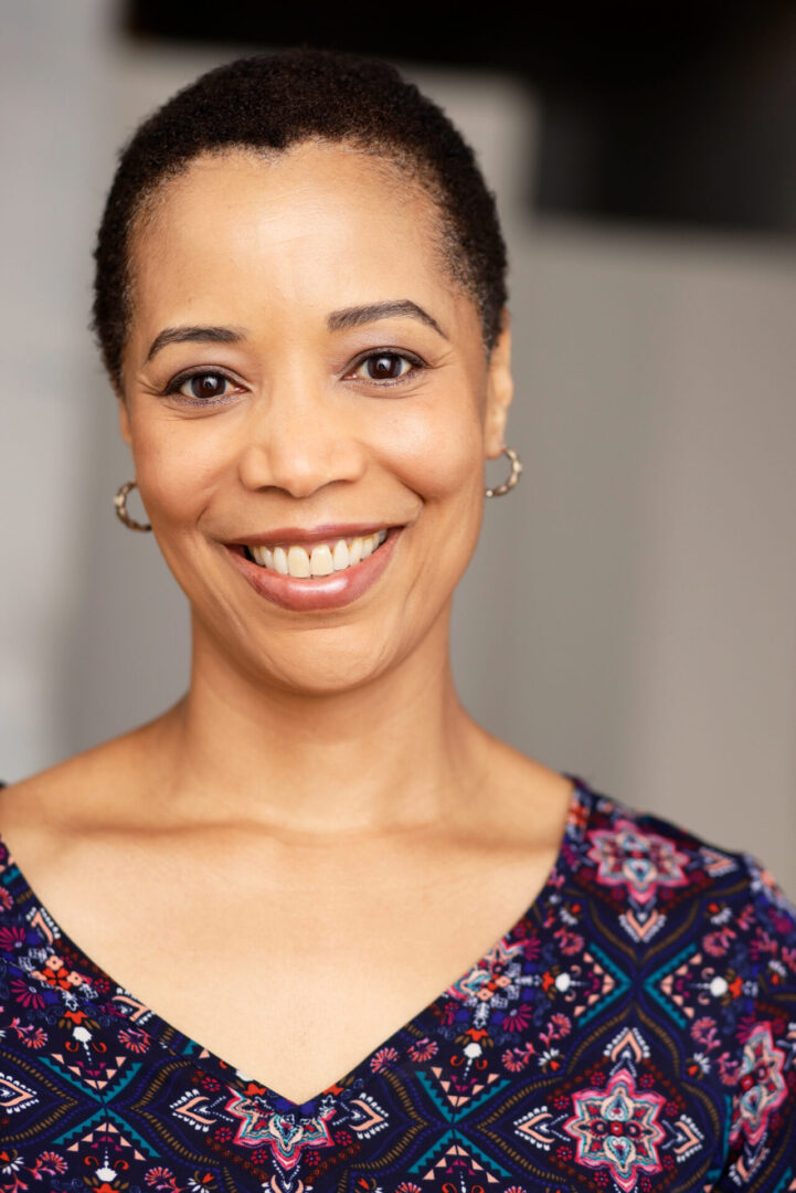 A woman smiling for the camera with her teeth missing.